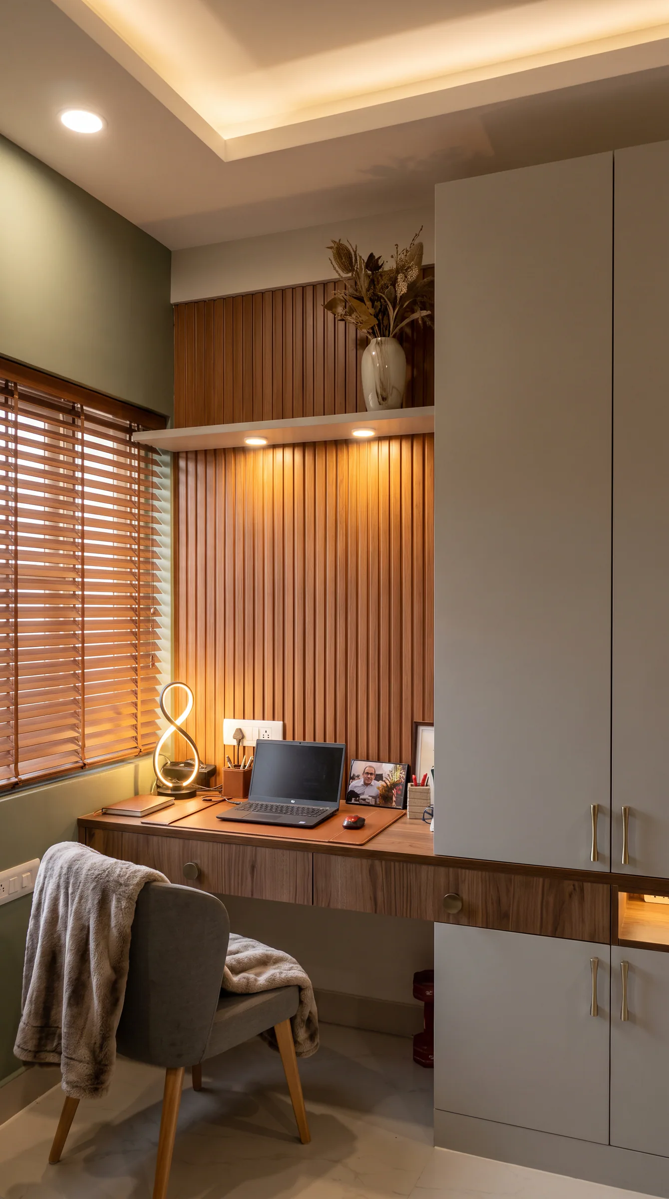 Window-side Islamabad home office with integrated storage and timber screening